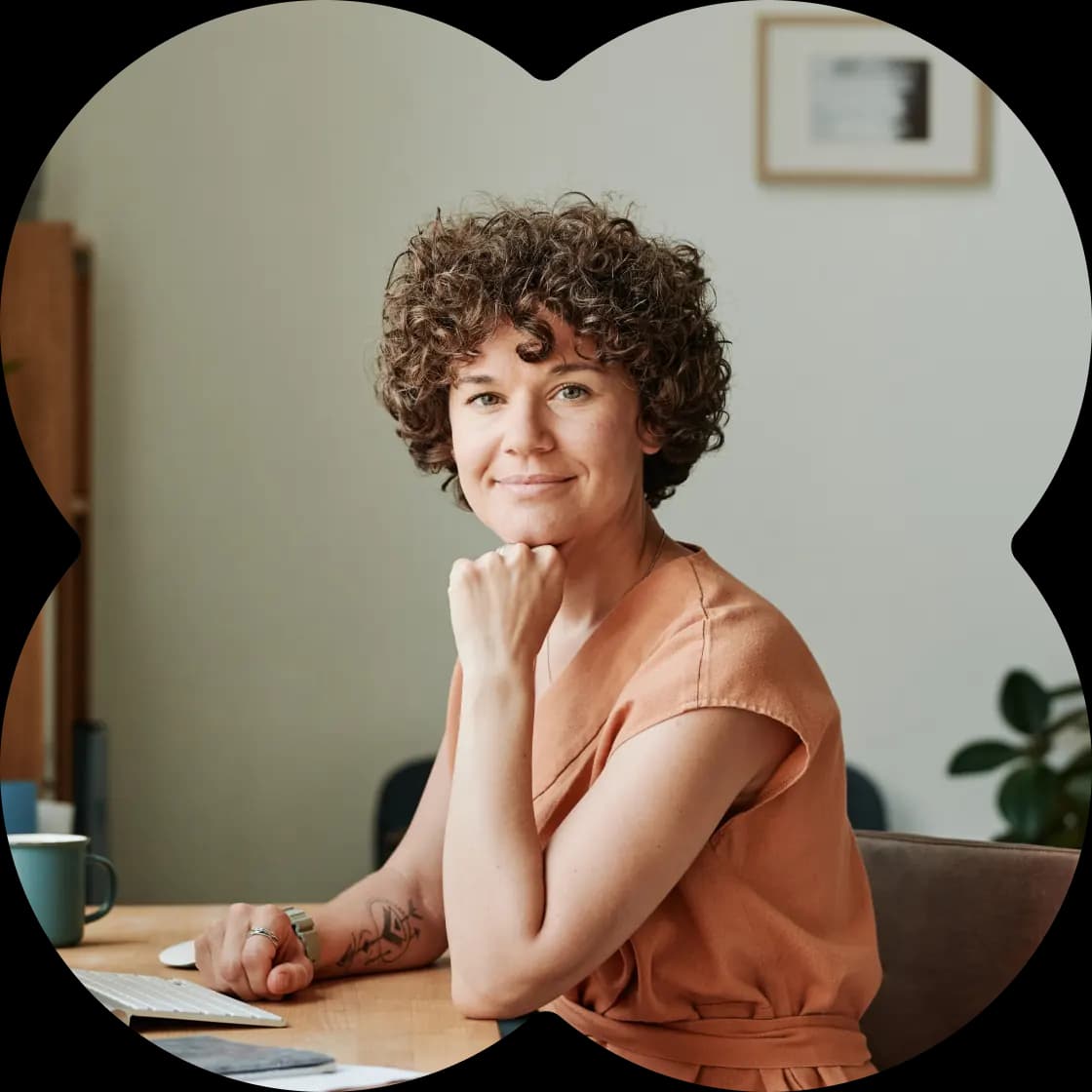 Femme souriante installée à son bureau